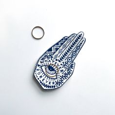 a blue and white hamsah with a ring on it