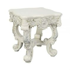 a white stool with ornate carvings on it