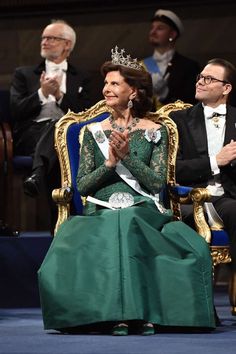 queen letizia of spain and her husband, king juan iv of spain sit on the throne