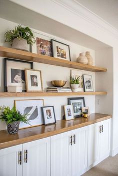 some shelves with pictures and plants on them