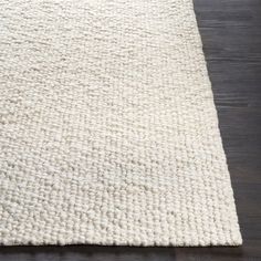 a white rug on a wooden floor