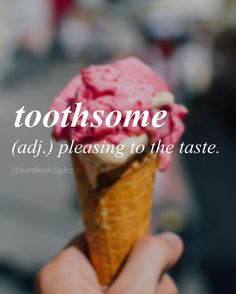 someone is holding up an ice cream cone with pink icing on it and the words, toothsome adj, pleasing to the taste