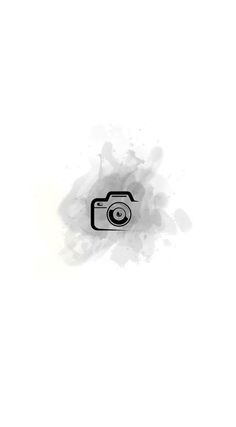 a black and white photo of a camera with watercolor splashes on it's side