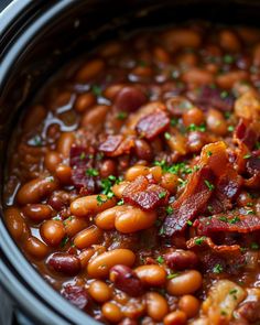 a crock pot filled with beans and bacon