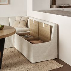 a living room with a couch, table and chair next to each other on a rug