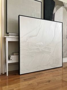 two large white marble slabs sitting on top of a hard wood floor