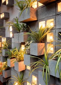 several cement planters with lights on them