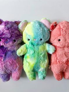 four stuffed animals are lined up in a row with the words mystery listing above them