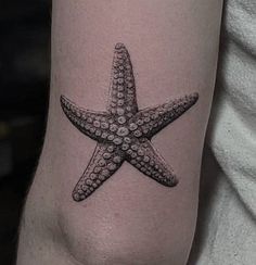 a small starfish tattoo on the arm