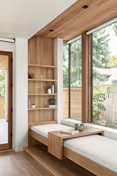 a living room filled with furniture next to a window covered in lots of wood planks