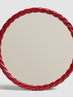 a round red rope mirror on a white background with room for your own text or image