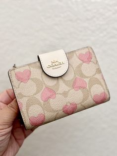 Coach Medium Corner Zip Wallet In Signature Canvas With Heart Print Brand new with tags 100% Authentic Limited Edition Color: Gold/Light Khaki Chalk Multi Product Details Signature coated canvas and smooth leather Seven credit card slots Bill compartment ID window Snap closure Zip coin pocket 5" (L) x 3 1/2" (H) x 1/2" (W) Style No. CQ146 Original Packaging! Same day shipping Coach Purse And Wallet Set, Small Coach Purse, Cherry Coach Wallet, Cute Coach Wallet, Coach Snap Wallet, Coach Wallet Keychain, Pink Coach Wallet, Wallets Aesthetic, Vs Wallet