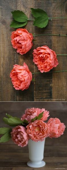 pink flowers in a white vase sitting on top of a wooden table