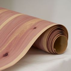 a roll of wood sitting on top of a white sheet