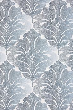 a blue and white wallpaper with an intricate design