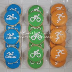 decorated cookies in the shape of triathlon symbols