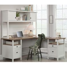 a white desk with a laptop on top of it next to a chair and window