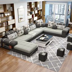 a living room filled with lots of furniture and bookshelves on top of a hard wood floor