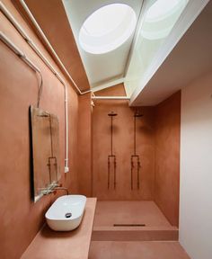 a bathroom with a skylight above it and a sink on the counter next to it