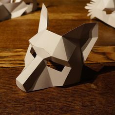 the paper dog is sitting on the table next to it's head cut out