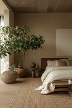 a bed sitting next to a potted plant in a bedroom