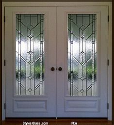 two white double doors with stained glass panels