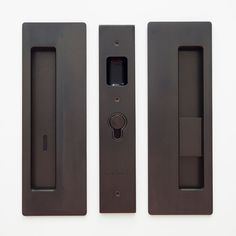 three black door handles on a white wall