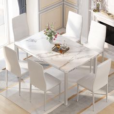 a marble dining table with white chairs and a fireplace in the backround area