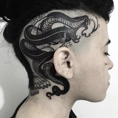 a woman with a dragon tattoo on her head