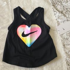 New The Nike Tank Is Sure To Be A Flowy Favorite. Featuring A Bright Graphic Print On Front And A Keyhole Detail On Back, This Tank Will Help Keep Kiddos Comfy At Play. Soft Cotton Fabric Feels Comfortable And Lightweight. Standard Fit For A Relaxed, Easy Feel. 100% Cotton Playful Black T-shirt For Spring, Black Summer Playwear Tops, Black Cotton Tops For Playwear, Playful Black Top With Letter Print, Playful Black Tops With Letter Print, Black Spring Playwear Tops, Sporty Graphic Print Tops For Playtime, Sporty Tops For Summer Playtime, Multicolor Graphic Print Tops For Playwear