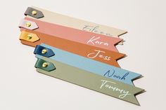 four name tags with different colors on them