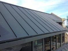 an image of a metal roof that is being installed on a house in the process of remodeling