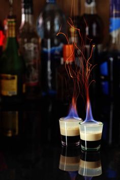 two glasses filled with liquid sitting on top of a table