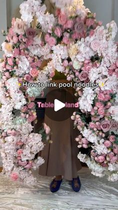 a woman standing in front of a large flower arrangement with the words how to link pool noodles