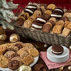 a basket filled with cookies next to other desserts and holiday decorations on a table