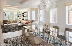 a dining room table with chairs and a chandelier hanging from the ceiling