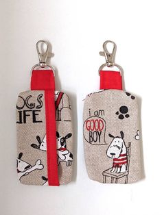 two small purses with key chains attached to them, one in red and the other in white