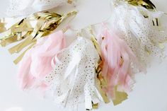 some pink and gold streamers on a white surface