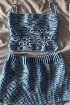 a crocheted skirt and top are laying on a bed with the bottom part missing