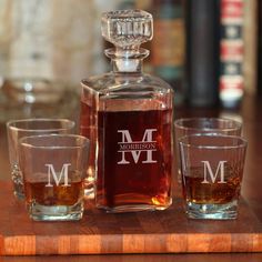 two shot glasses and a decanter on a wooden tray with the name morgan