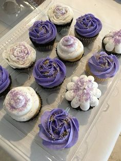 cupcakes with purple frosting and sprinkles in a plastic container