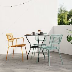 three chairs and a table on a patio