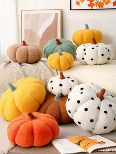 several pumpkins are sitting on the couch