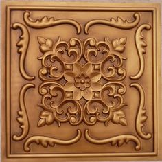 a square metal ceiling tile with an intricate design on the center and sides, in bronze