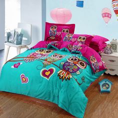 an owl themed bed with pink and blue comforters