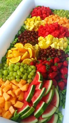 a large white bowl filled with lots of different types of fruit