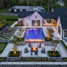 an aerial view of a house with a fire pit in the center and lawn area