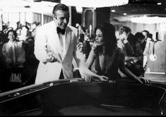 a man and woman standing next to each other in front of a pool table at a casino