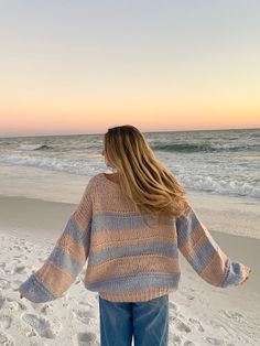 The Poppy Blush and Blue Striped Oversized Sweater is the coziest and cutest sweater for your day-to-day outfits! Blush and blue striped fabric shape this oversized sweater with a round neck, a tunic length, and bubble sleeves. Features ribbed accents at the hem. Style your favorite baggy jeans for a casual look. DETAILS & CARE 55% Cotton/30% Acrylic/15% Nylon Hand wash cold. Imported. Beachy Sweater Outfit, Beachy Aesthetic Clothes, Cold Beach Day Outfit Winter, Beachy Sweaters, Cold Summer Days Outfits, Beachy Winter Outfits, Beachy Outfits Aesthetic, Beachy Fits, Beach Sweaters