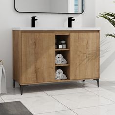 a bathroom with a sink, mirror and toilet paper roll holder on the counter top